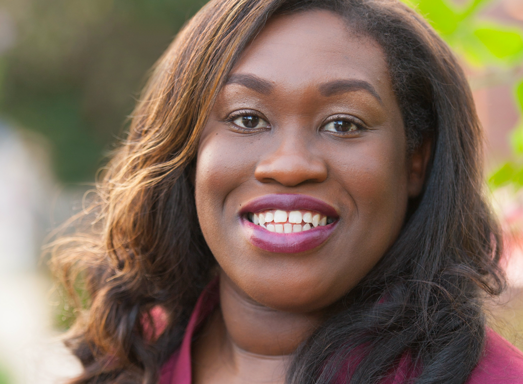 Dr. Natasha Jones, a Black woman in a pink top, smiling.