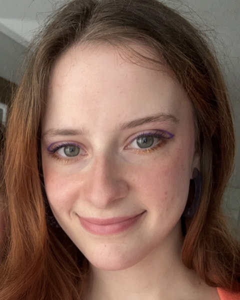 Headshot of Moly Mingo, a young  white feminine person with radish brown hair