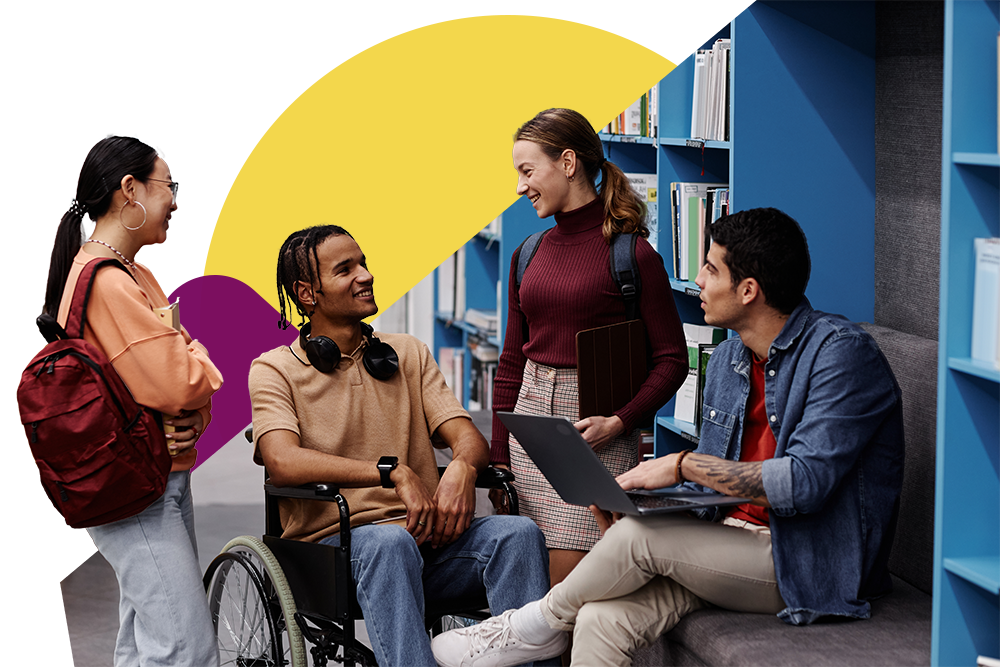 A diverse group of students talk in a library