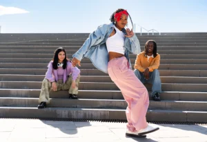 Young group of multiethnic hip-hop dancers wearing colorful urban streetwear dancing