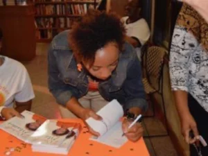Angela Glass, a black woman, signing books in Fort Smith, AR.